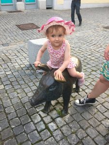 Kind in Günzburg auf Bronzeschwein