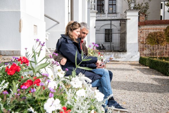 Paar liest auf Bank vor Museum